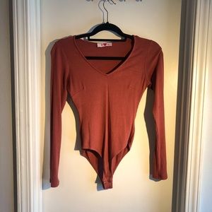 Buddy love burnt orange body suit.